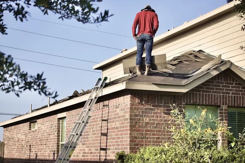 Professional roofer working on a residential roof in Clemson University